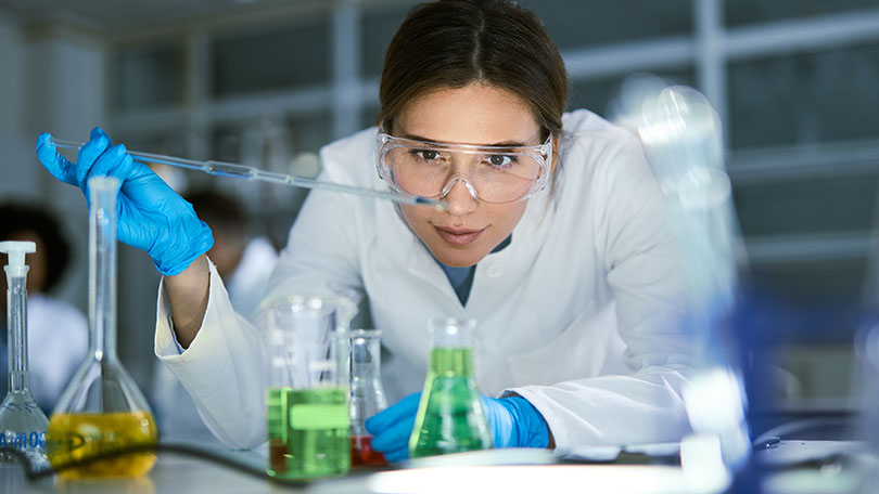 Wissenschaftlerin untersucht Pflanzen in einer kontrollierten Anbauumgebung